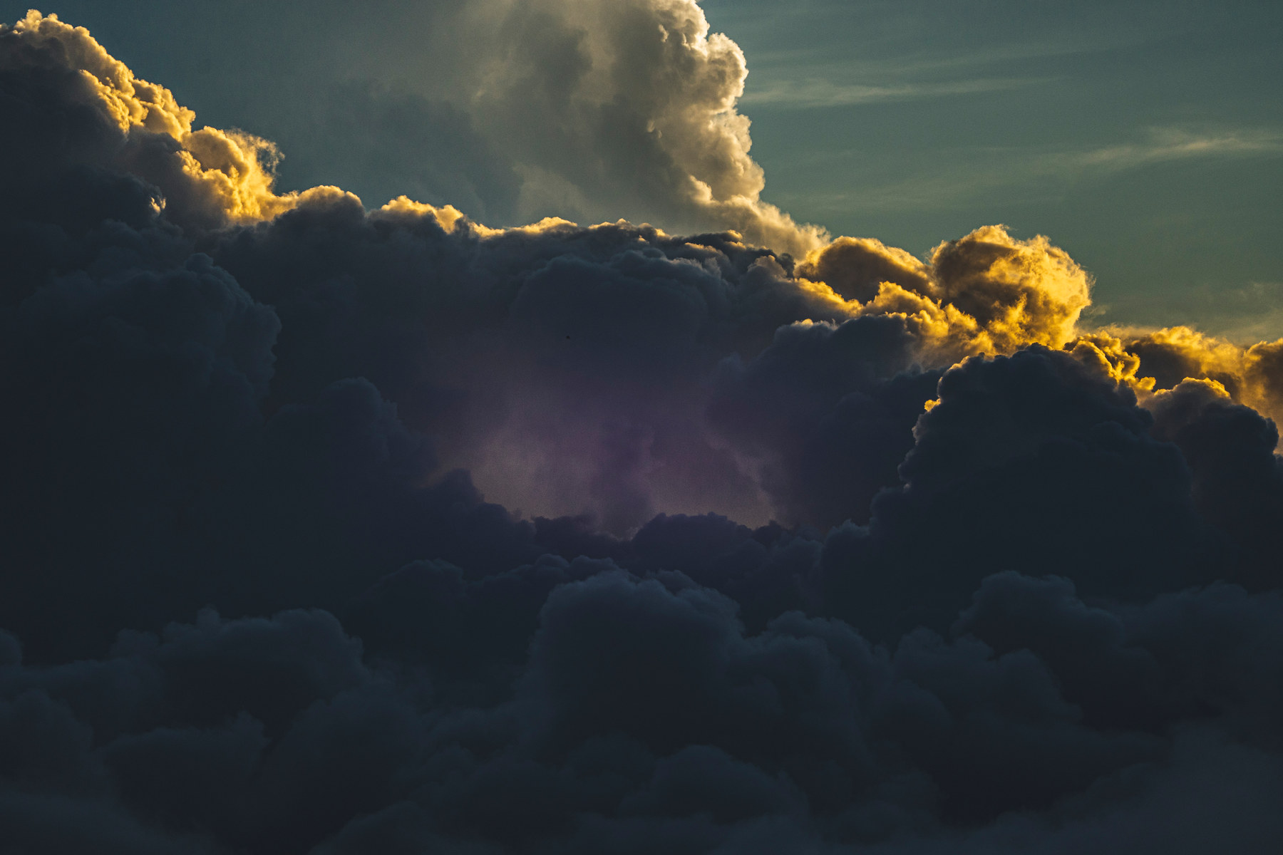 Storm cloud, sun behind it